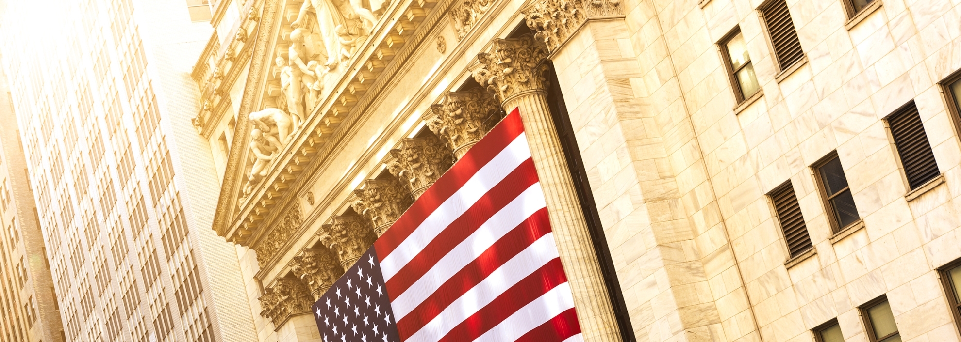 Front of New York Stock Exchange with American Flag